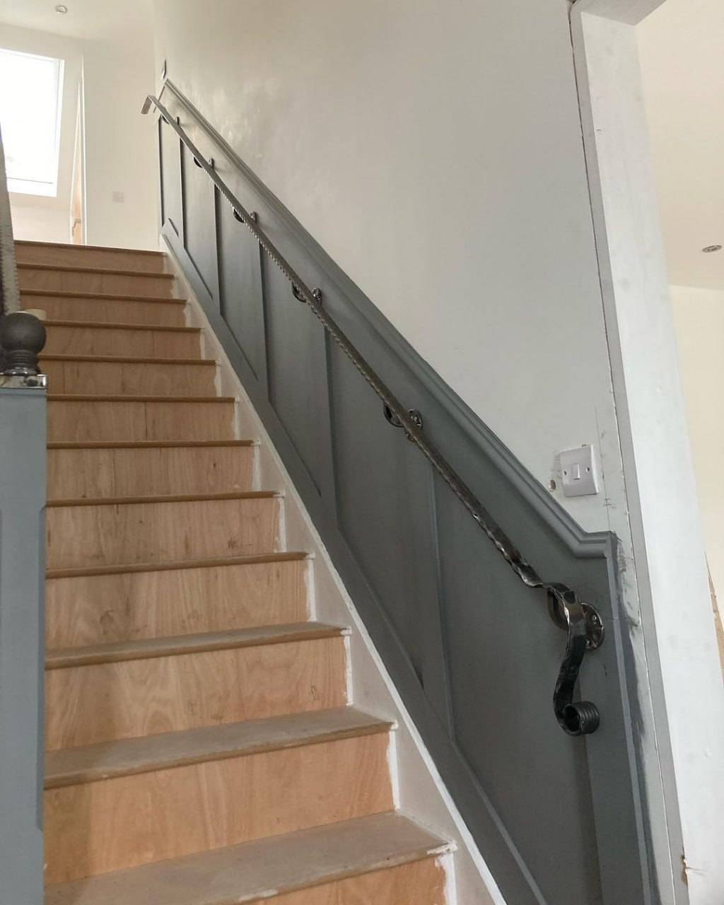 Straight staircase with painted panelling stringer and period handrail brackets
