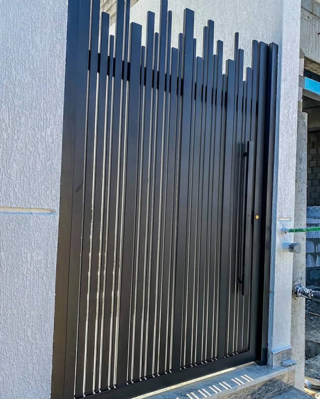 Freestanding single slatted steel gate leaf showing the full slat profile