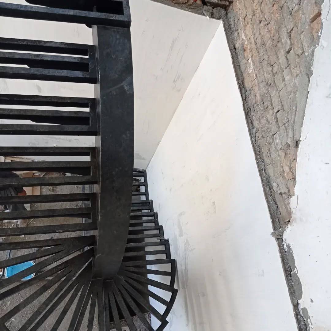 Detail view of wedge steel treads fanning around a central spiral column